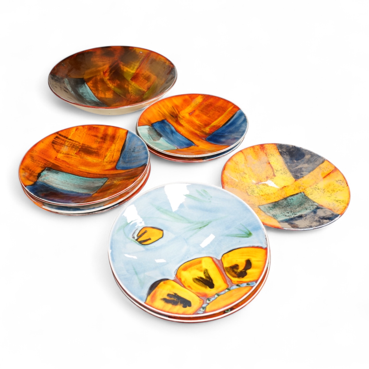 A Poole pottery ‘Gemstones’ fruit bowl and set of five smaller matching dishes, a similar patterned dish and two ‘Wild Poppy’ dishes. Fruit bowl 34cm diameter.